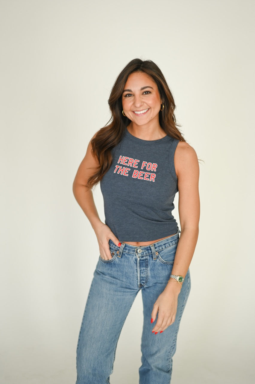 Woman wearing a high neck tank top with "Here for the Beer" on it