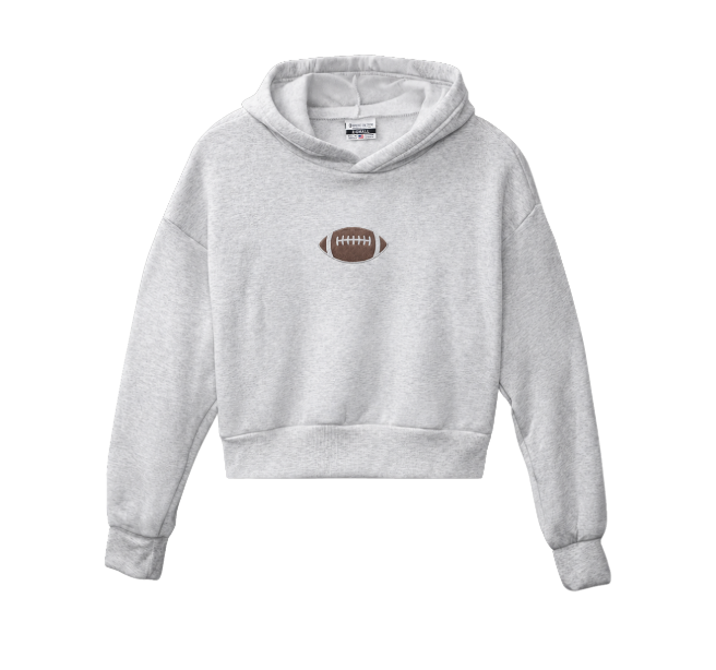 A light heather gray cropped hoodie sweatshirt featuring a small brown American football graphic printed on the center chest, displayed against a solid white background.