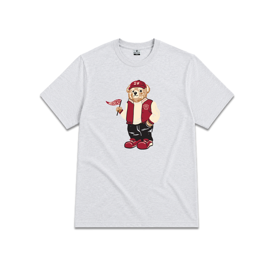Light gray short-sleeve crewneck t-shirt, graphic of a teddy bear wearing a IU red varsity jacket, red cap, and black pants, holding a small red and white flag.