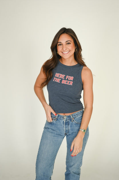 Woman wearing a high neck tank top with "Here for the Beer" on it 