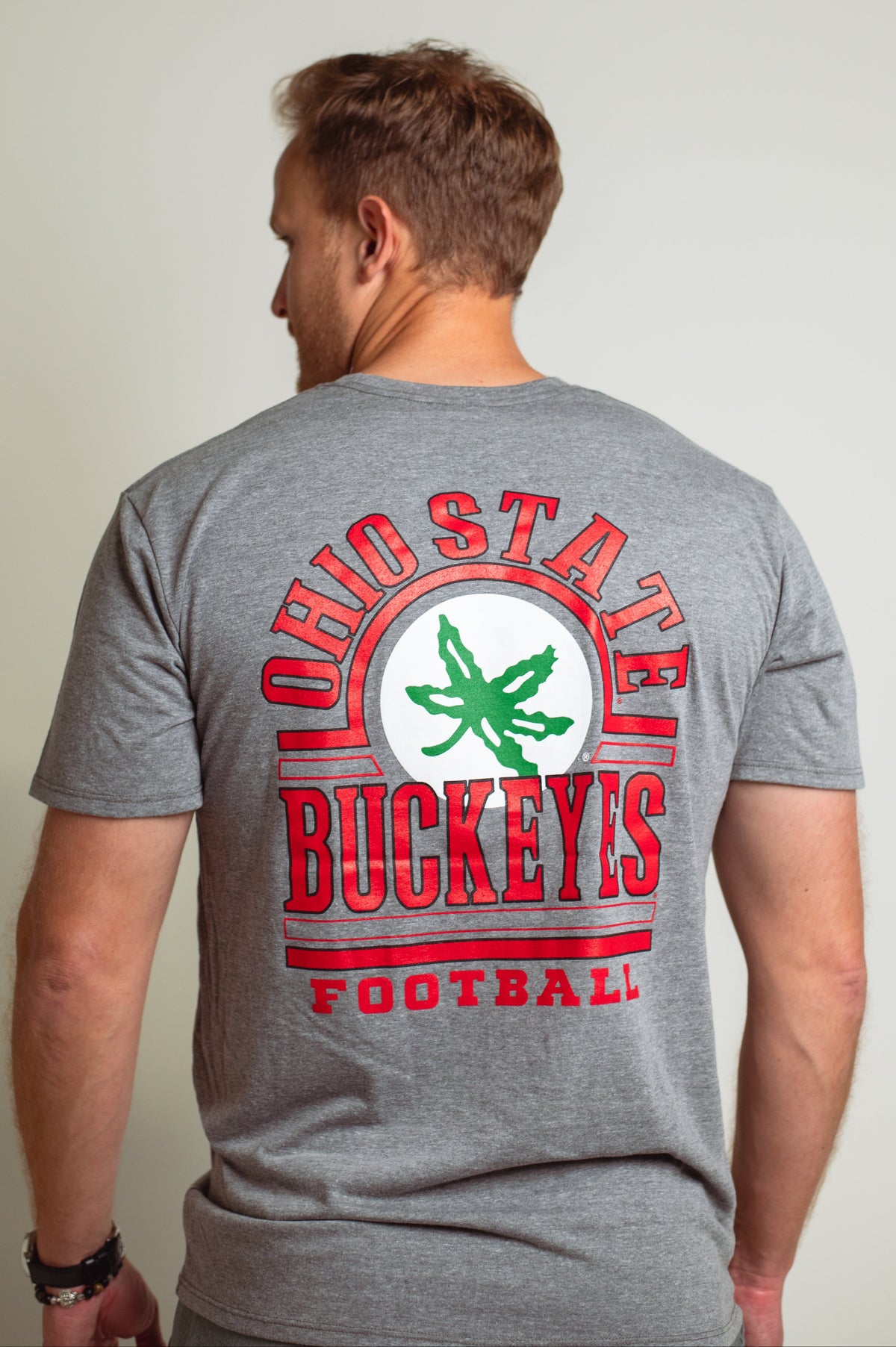 Gray Ohio State University unisex tee, Ohio State Buckeyes football, Helmet decal on back, modeled