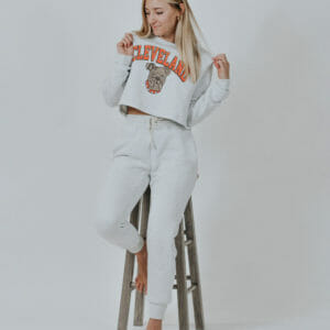 Woman modeling our Cleveland Ash lounge set, which includes our Cleveland Dawg Arch Crop Sweatshirt and our ash joggers.