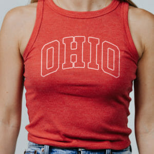 Woman wearing a red high neck tank that features the word Ohio spelled out.